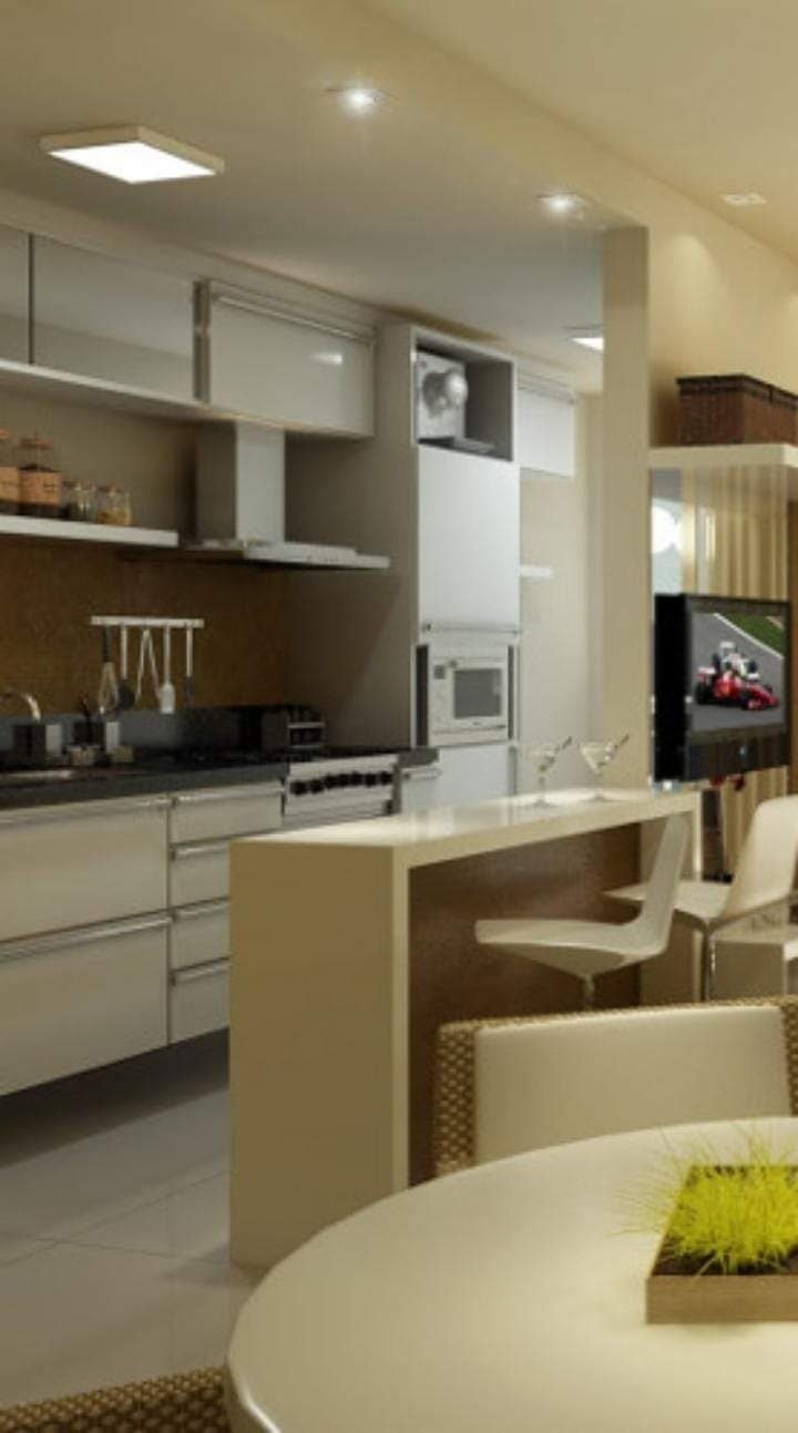 Cozinha integrada com bancada e sala em Carapicuíba